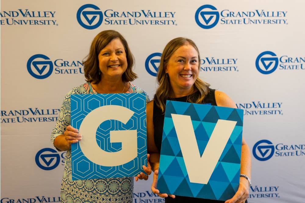 Susan Sigler, holding the G sign, and Megan W holding the V sign